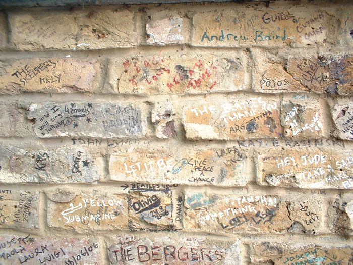 The visitors who write on the wall are from all over the globe