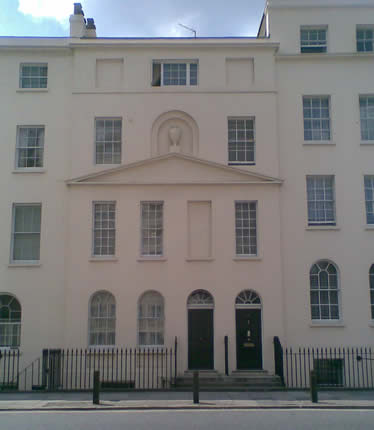 31 and 33 Albany street seen from across the road, the top window of the building is open.