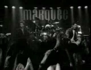 "I'm your man" video, Wham! in concert, the Marquee sign behind the stage visible