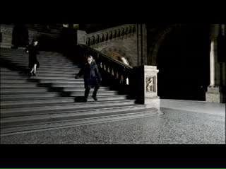 Girl chases boy down the staircase of the main hall